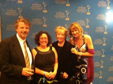 Four people posing for a photo at the emmy awards.