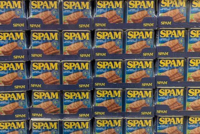 A stack of spam boxes on a shelf.