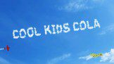 The word cool kids cola is written in the clouds.