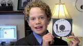 School boy holding a CD casset