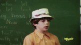 Boy kid in front of green board