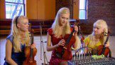Three girls with blonde hair holding violin