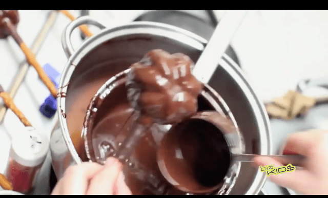 A person is pouring chocolate into a pot.