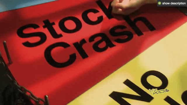 A person is holding up a sign that says stock crash.