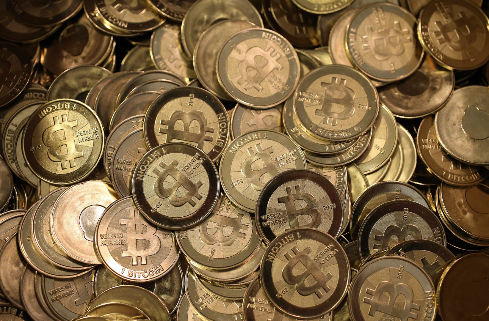 A pile of gold and silver bitcoin coins.