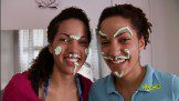 Twin sisters playing with creme
