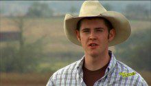 Man at the field wearing a hat