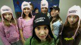 Girls gang posing for selfie wearing winter cap