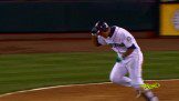 A baseball player running to first base during a game.