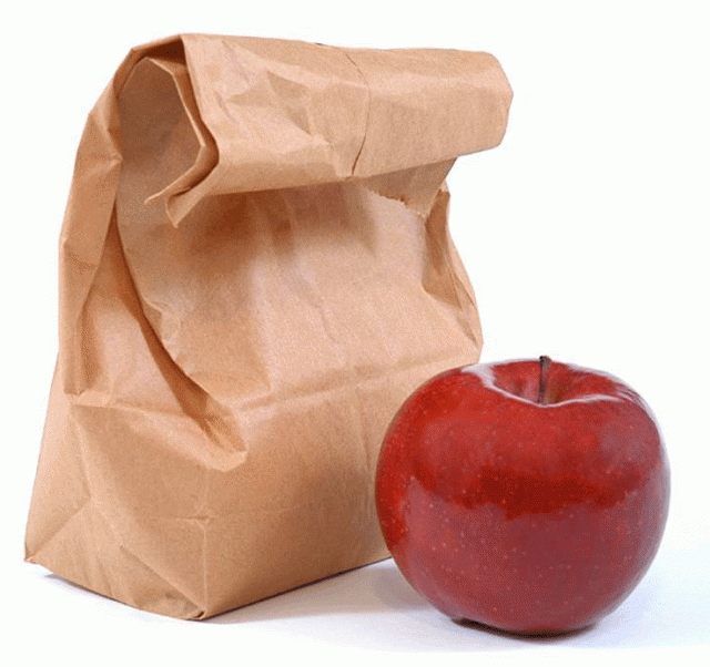 A brown paper bag next to an apple.