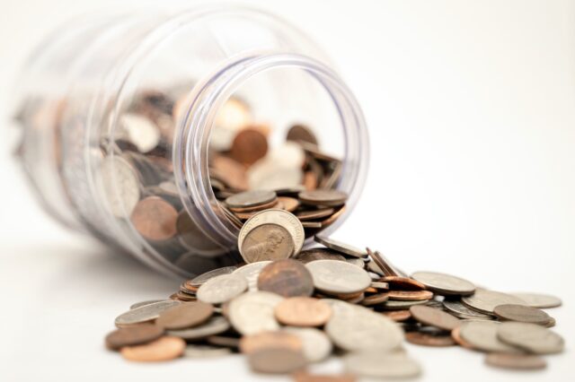 A jar full of coins on a white background.