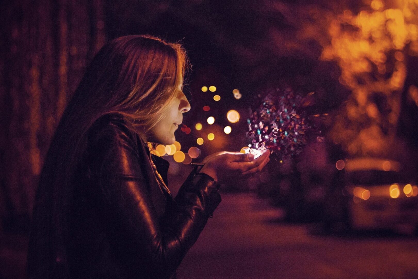A woman is holding a sparkler in her hand.