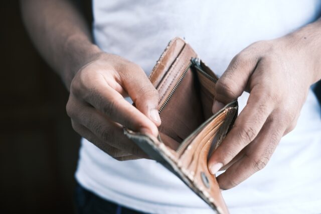 A person opening his empty pocket