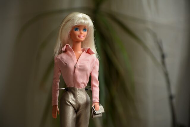 Close up shot of a bay barbie doll with pink shirt