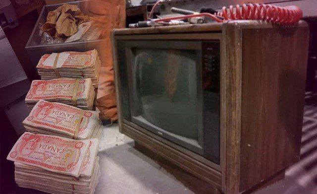 A tv sitting on top of a pile of money.