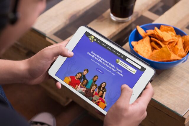 Kids looking ipad with a bowl of chips