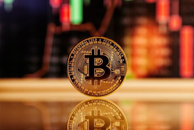 Closeup of a Bitcoin and reflection on the table