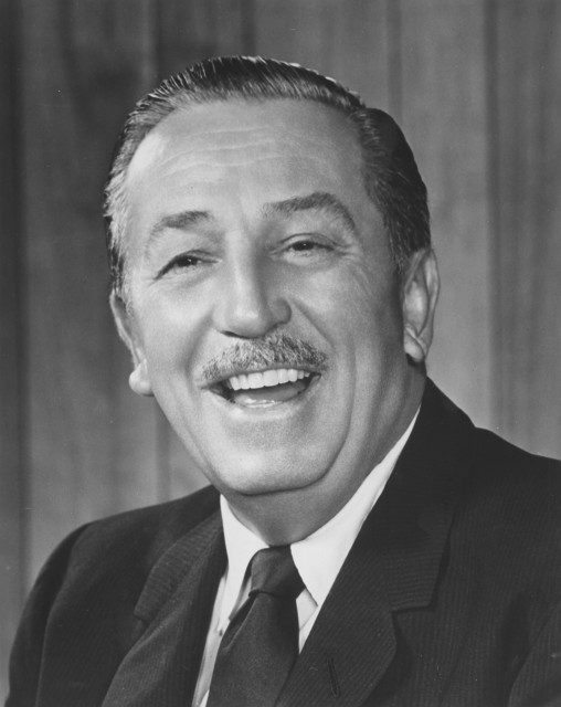 A black and white photo of a man smiling.