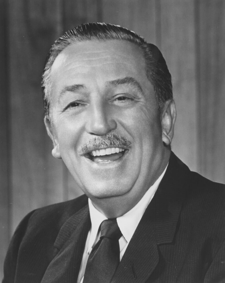 A black and white photo of a man smiling.